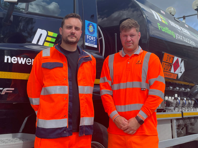 New Era Energy employees standing beside Fuel tanker